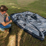 Inflating the Often Sunday with a hand pump, tent laid flat on grass before pitching