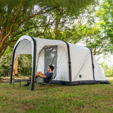 Often Sunday tent pitched under trees with a camp chair set up beneath the canopy