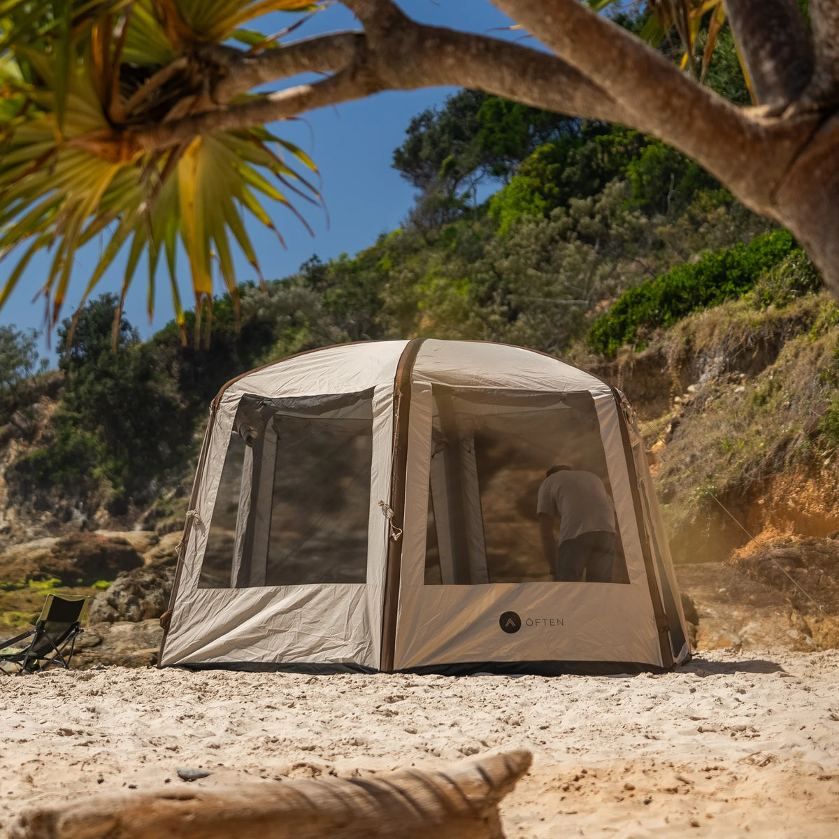 Often Bunker inflatable hexagonal glamping tent pitched on a Queensland beach under a pandanus